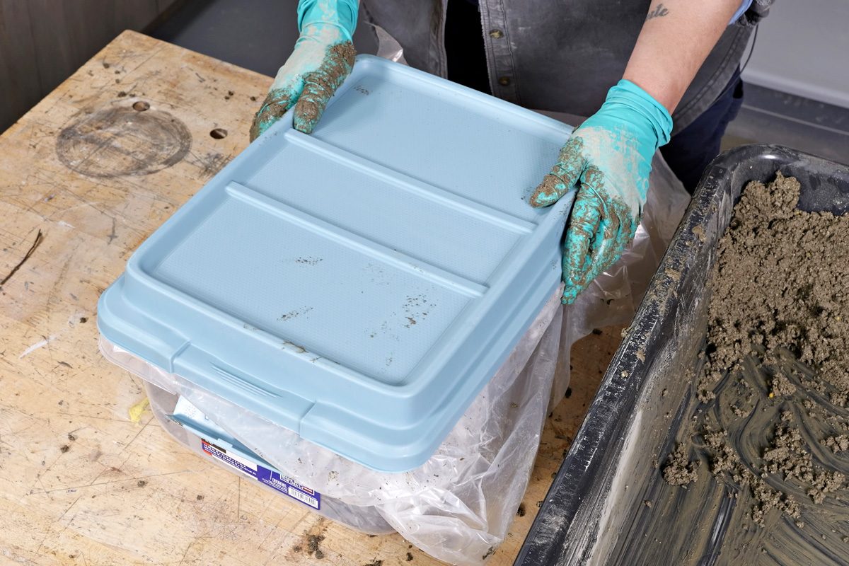 placing plastic lid over hypertufa mixture