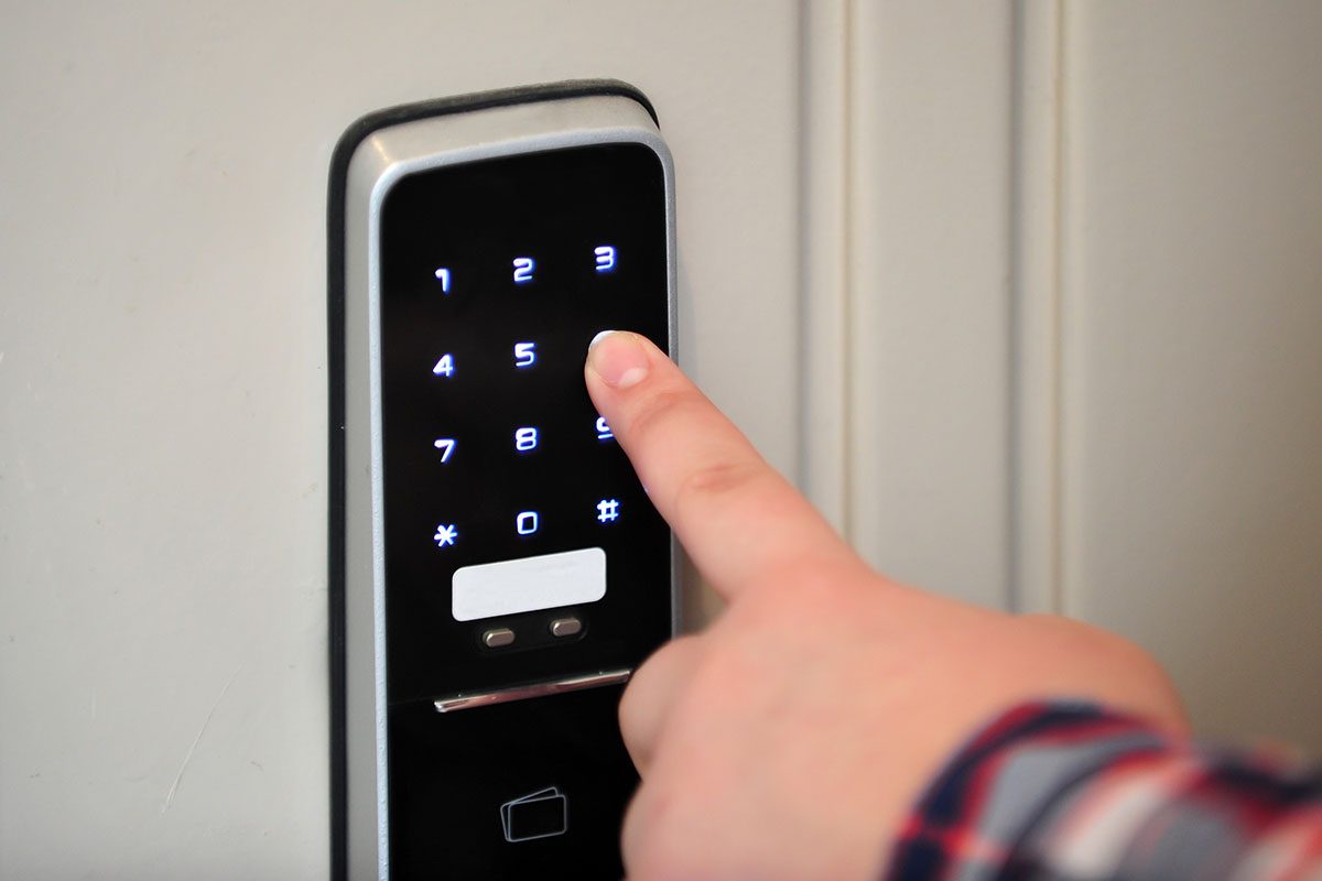 Person entering the passcode to open the door