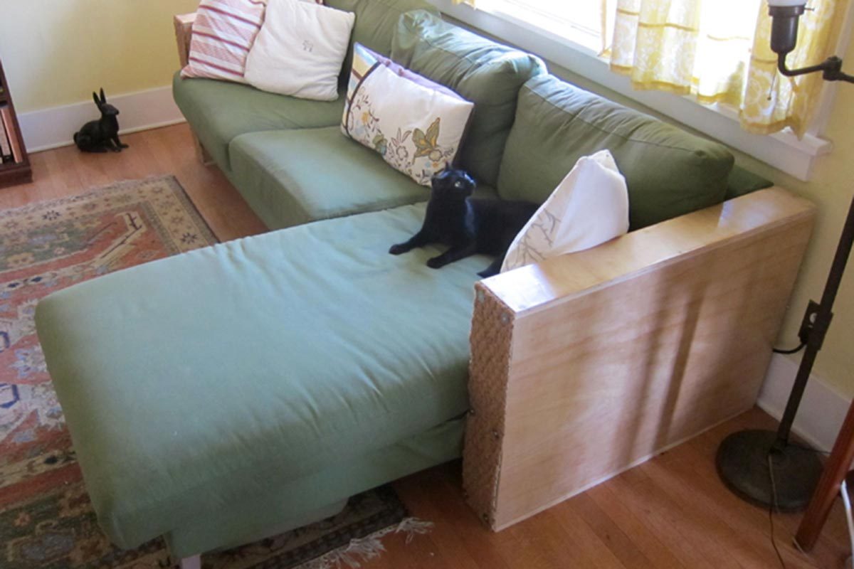 Green couch with cat and side table