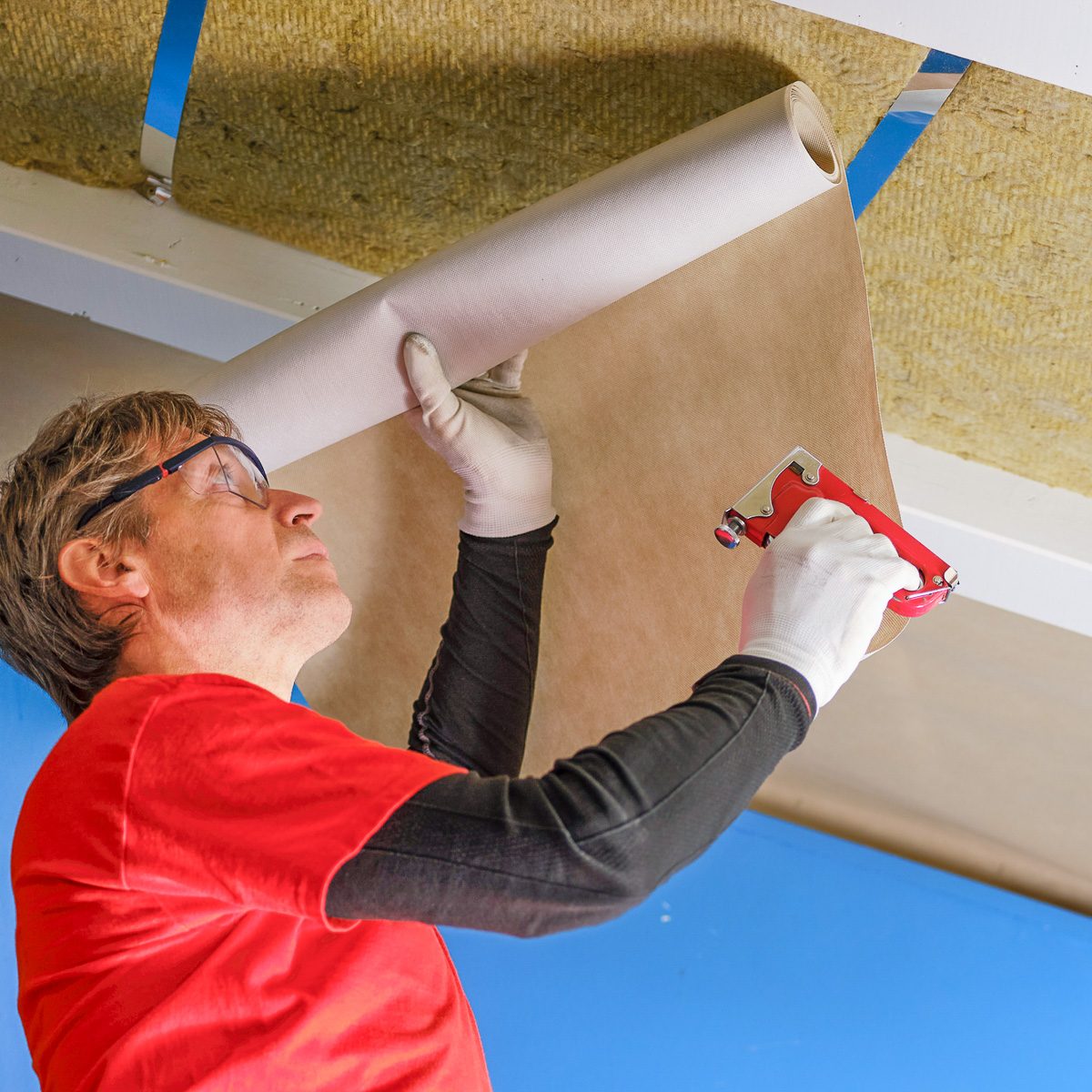 man applying anti vapor sheet