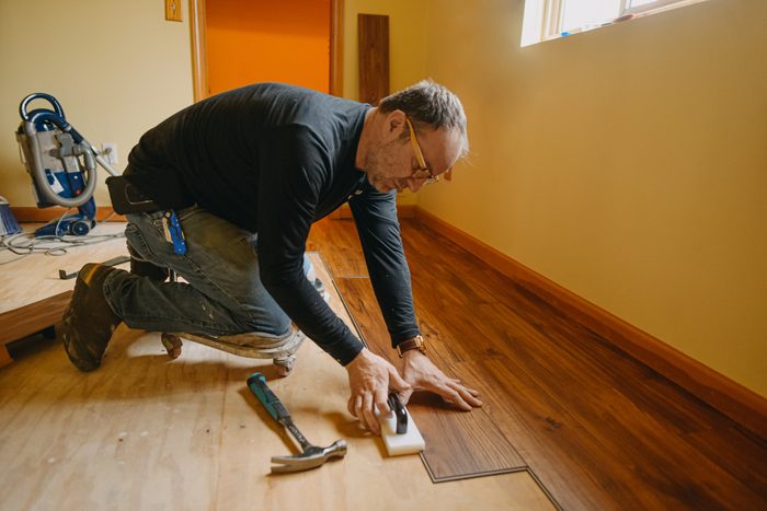 Man Installing Wood Floor