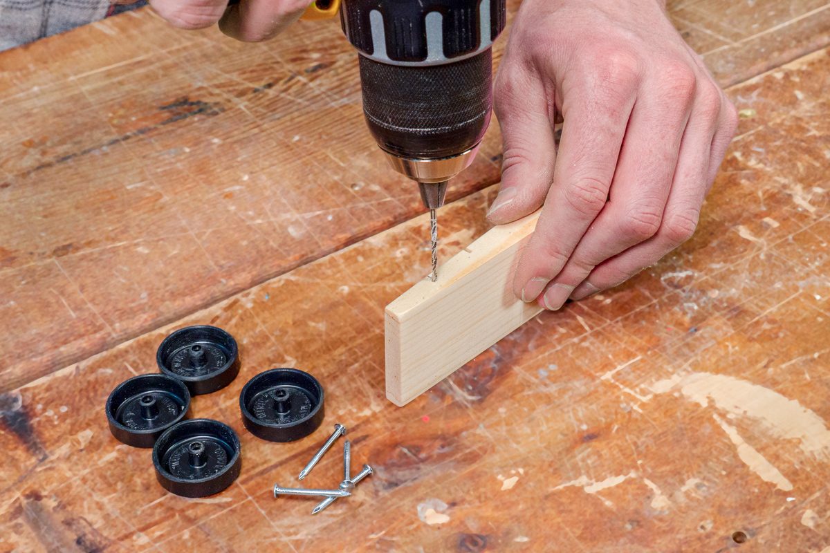 drilling a hole into a wooden wedge