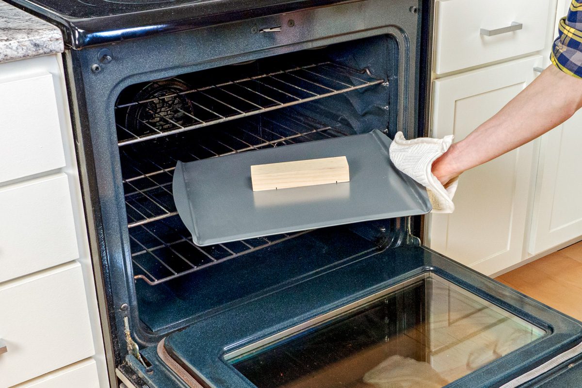putting wooden block in oven