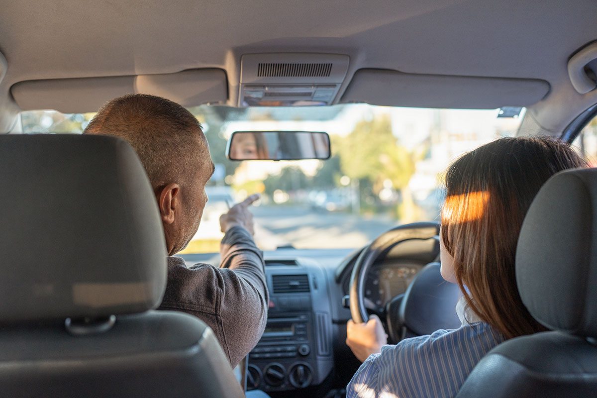 Male Driving Instuctor Points Out Hazards On The Road