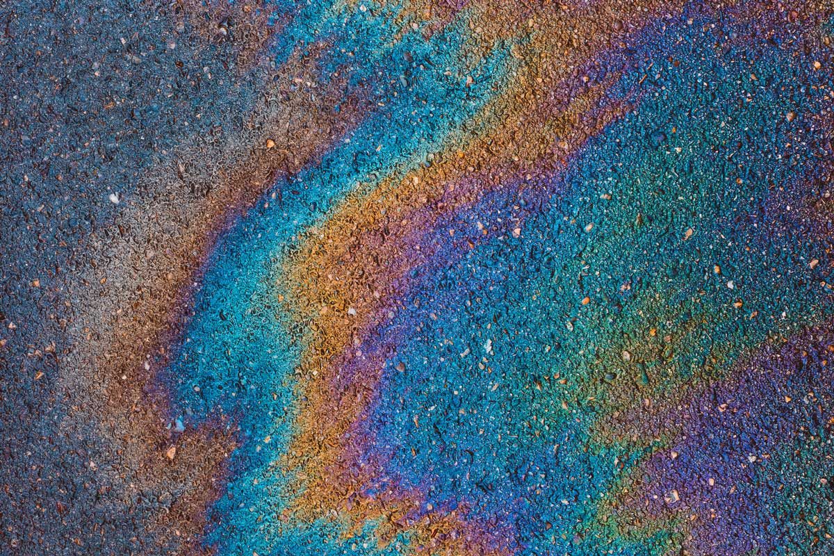 oil leaked from vehicle onto road