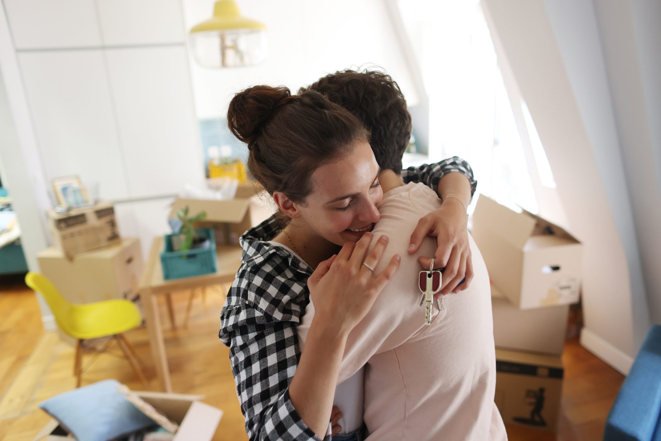 A happy young couple move into a new apartment