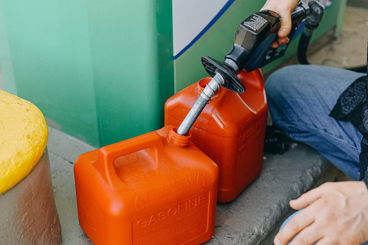 close up of man filling gasoline canister