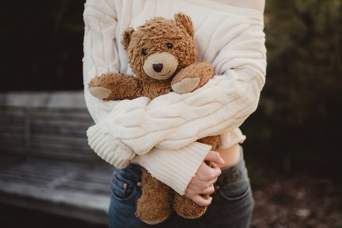 close up of girl holding teddy bear