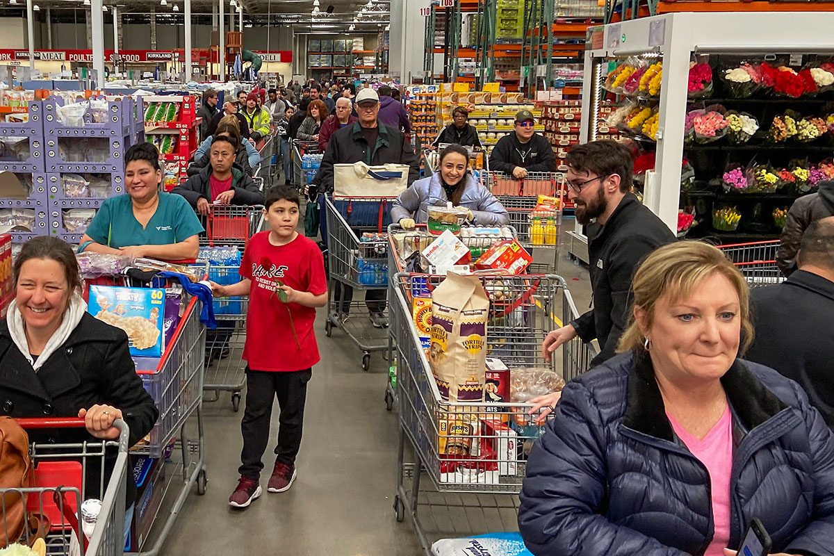 Shoppers flooded Costco causing a check-out line stretching to the back of the store as they stocked up on household
