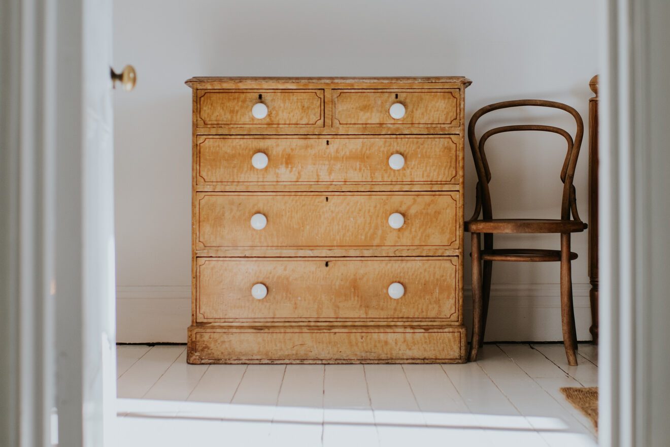 Simple image of a chest of drawers through a doorway