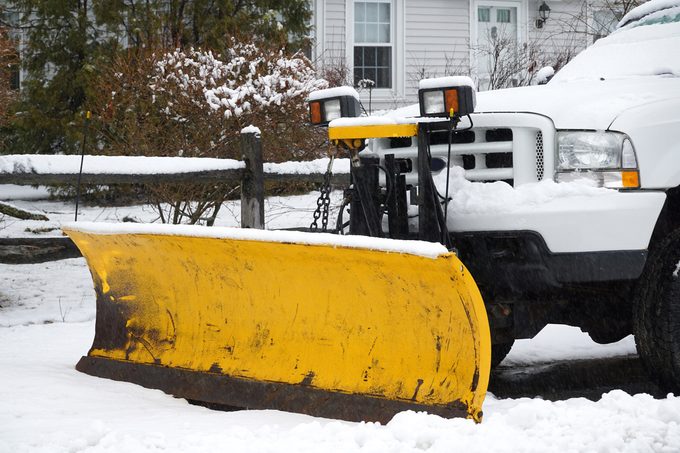 close up of snow plow attachment in front of truck