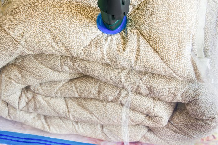 plastic bag with blanket being vacuum sealed