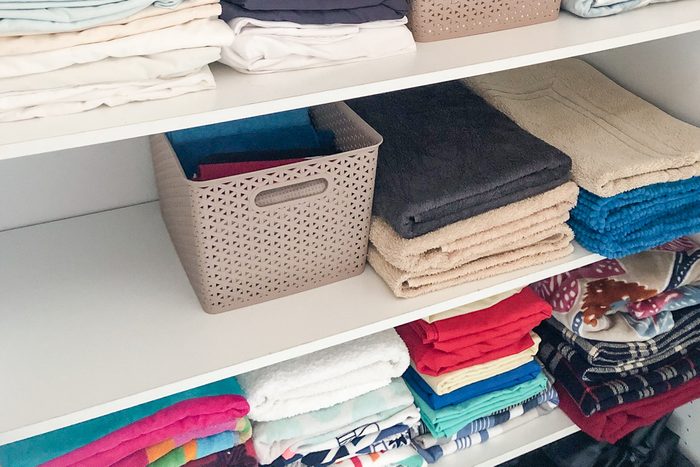 shelves with clothes and linens in a closet