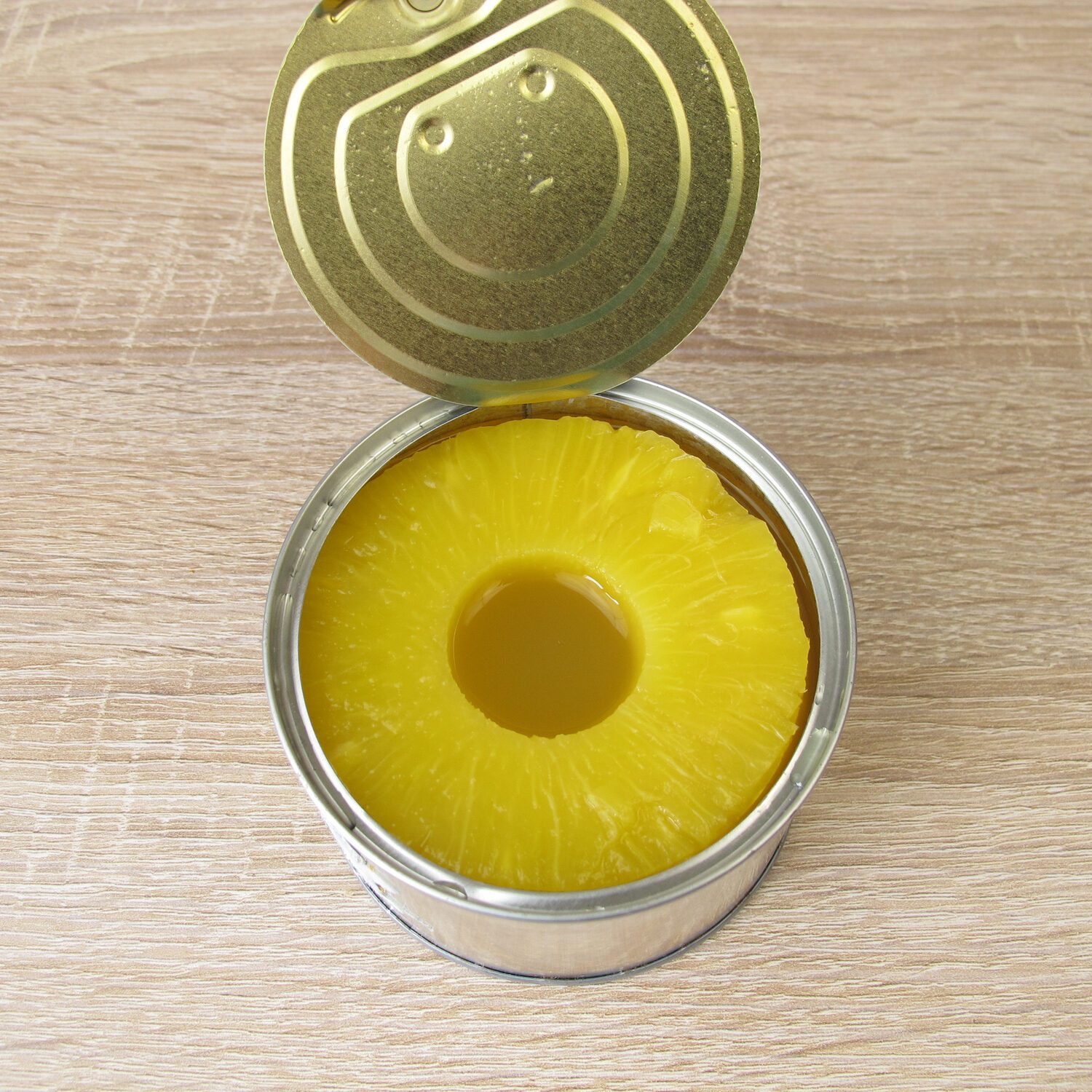 A can of pineapple slices in juice