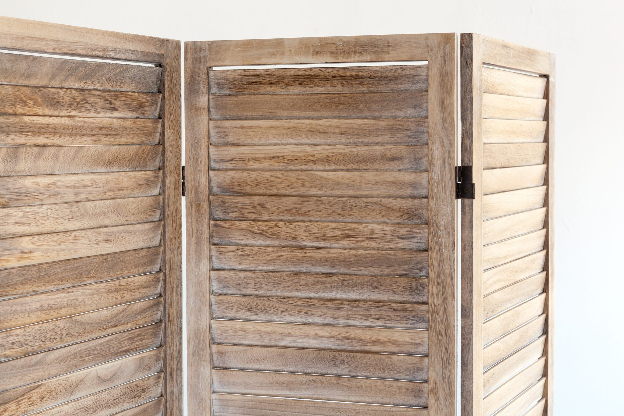 Close up of wooden folding screen.