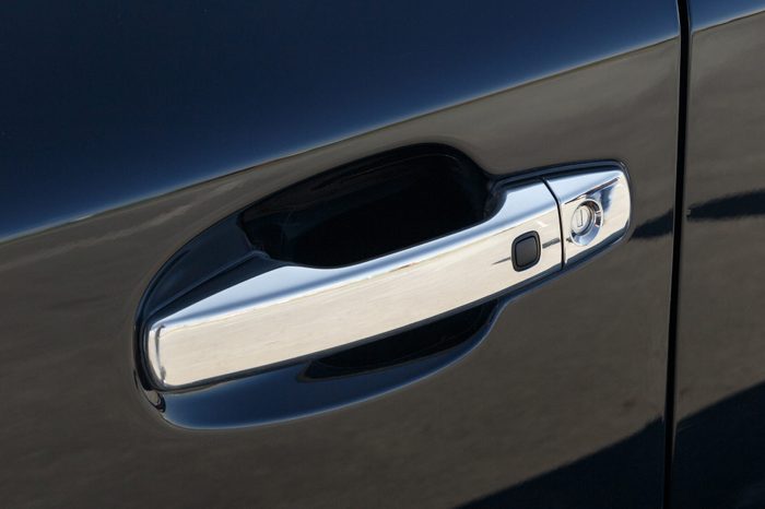 The chrome-plated door handle of a modern black car. Close-up car detail. Car Keyless entry system. Modern security systems
