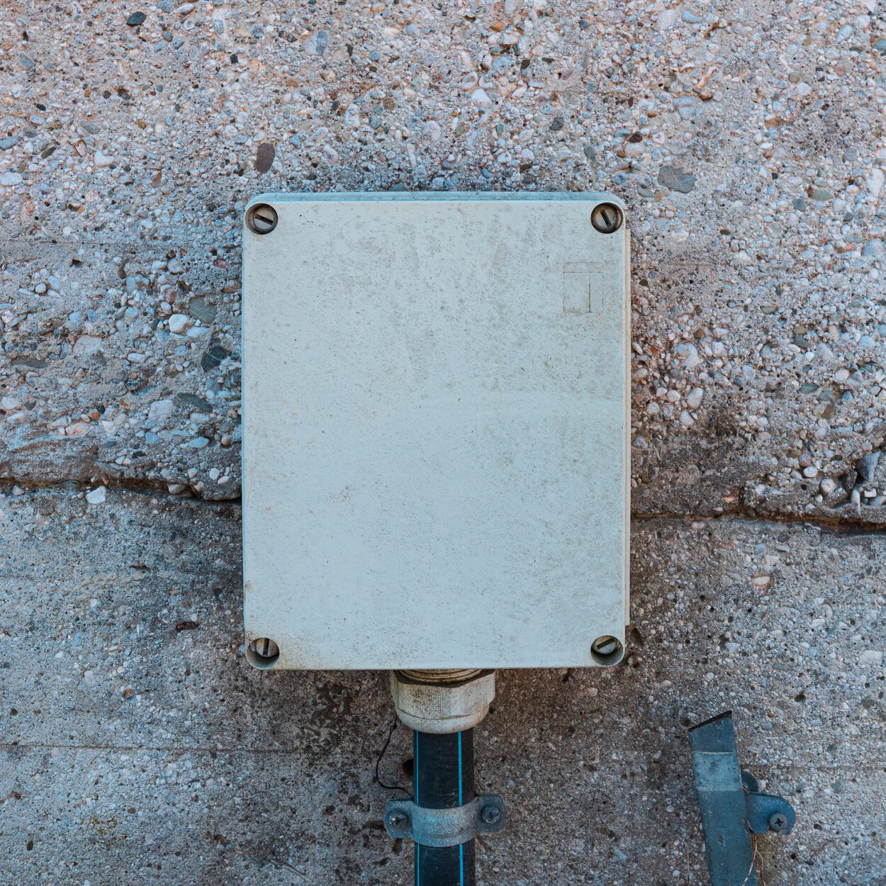 Exterior plastic electrical box mounted on concrete wall