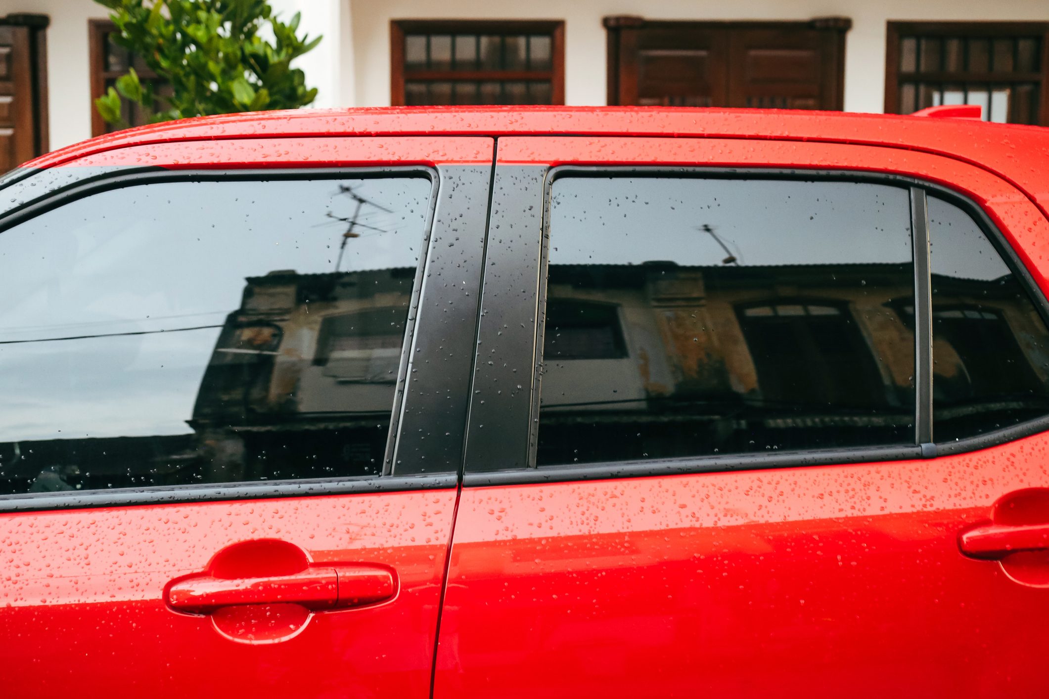 George Town cityscape seen through car's mirror window - tradition vs modernity