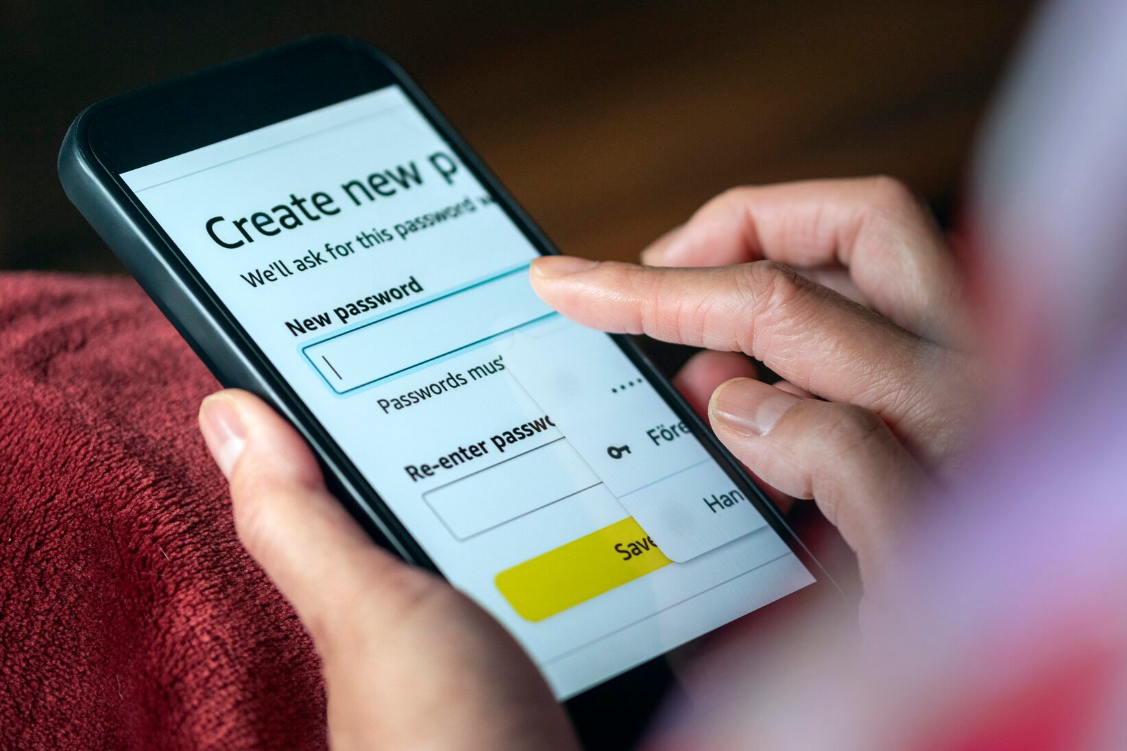 Close-up of resetting password on mobile phone