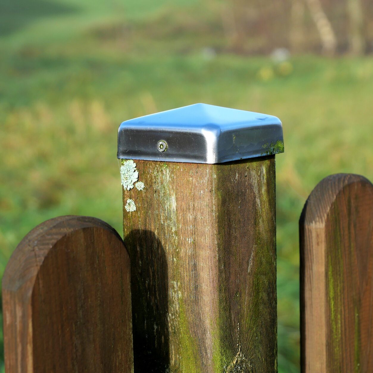 Fence posts with polished sheet metal fence caps