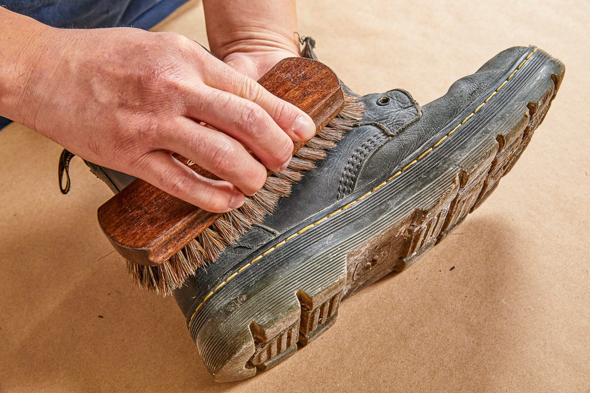 brushing away debris from boots
