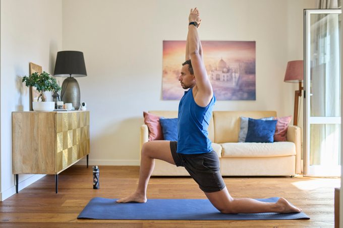 Man in Athletic Wear Practicing Yoga at Home