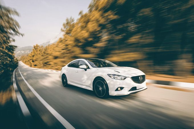 Car Mazda driving on road at daytime