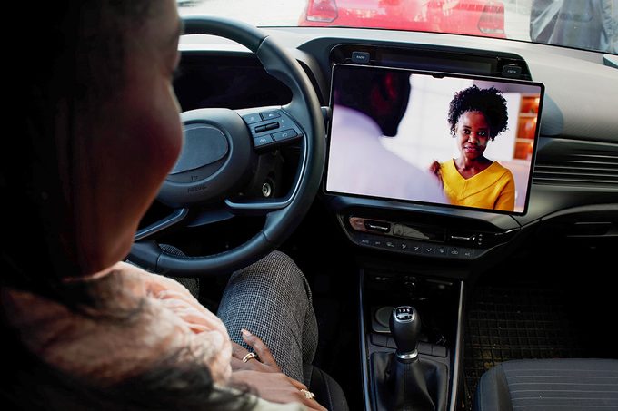 Woman Driving Luxury Car, Watching New Movie