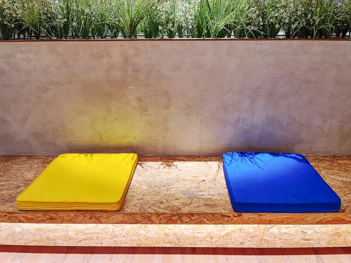 Plywood under cushions on bench with open slats